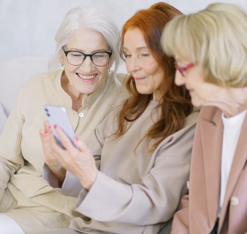 Three women videochatting on a phone